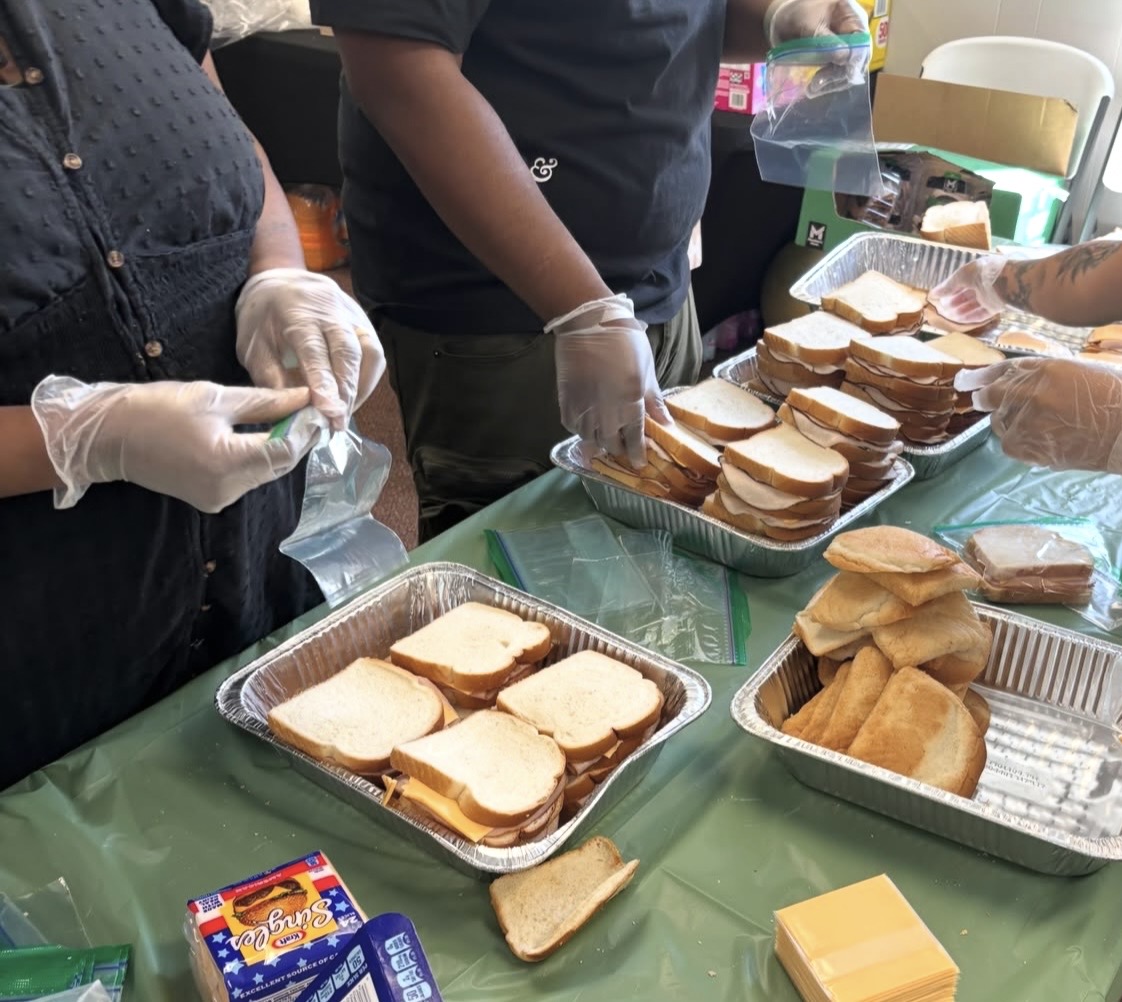 Volunteers assembling food for the community.